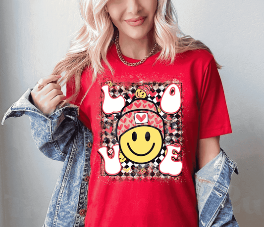 The Smiley Love Red - Valentine Graphic Women's Tee Shirt is an adorable and comfortable addition to your wardrobe. Made with soft cotton and featuring a bright smiley face design, this tee is sure to spread joy wherever you go.