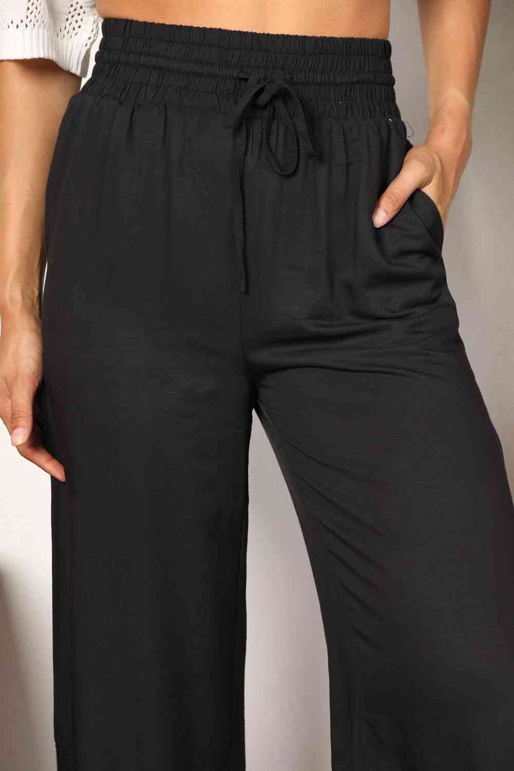 Crafted with a drawstring-smocked waist, these Women's wide-leg pants offer comfort and a flattering silhouette. Their extended length exudes elegance, making them suitable for casual or formal settings. Effortlessly stylish and versatile, these pants are an excellent choice for creating trendy yet comfortable ensembles.