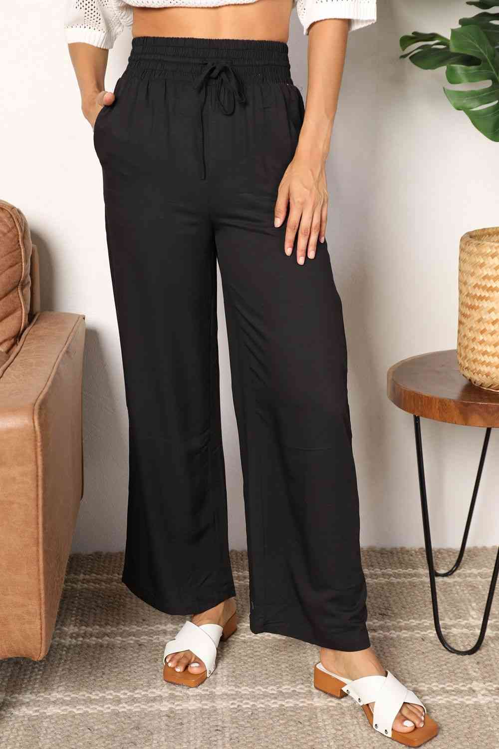 Crafted with a drawstring-smocked waist, these Women's wide-leg pants offer comfort and a flattering silhouette. Their extended length exudes elegance, making them suitable for casual or formal settings. Effortlessly stylish and versatile, these pants are an excellent choice for creating trendy yet comfortable ensembles.