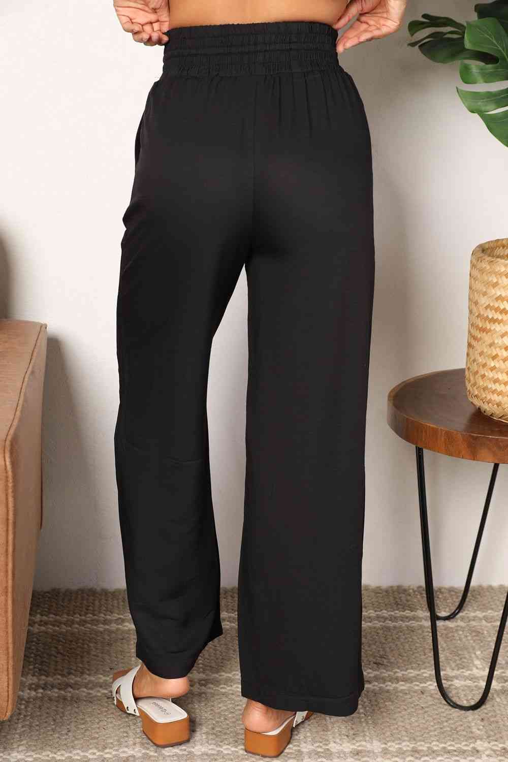 Crafted with a drawstring-smocked waist, these Women's wide-leg pants offer comfort and a flattering silhouette. Their extended length exudes elegance, making them suitable for casual or formal settings. Effortlessly stylish and versatile, these pants are an excellent choice for creating trendy yet comfortable ensembles.